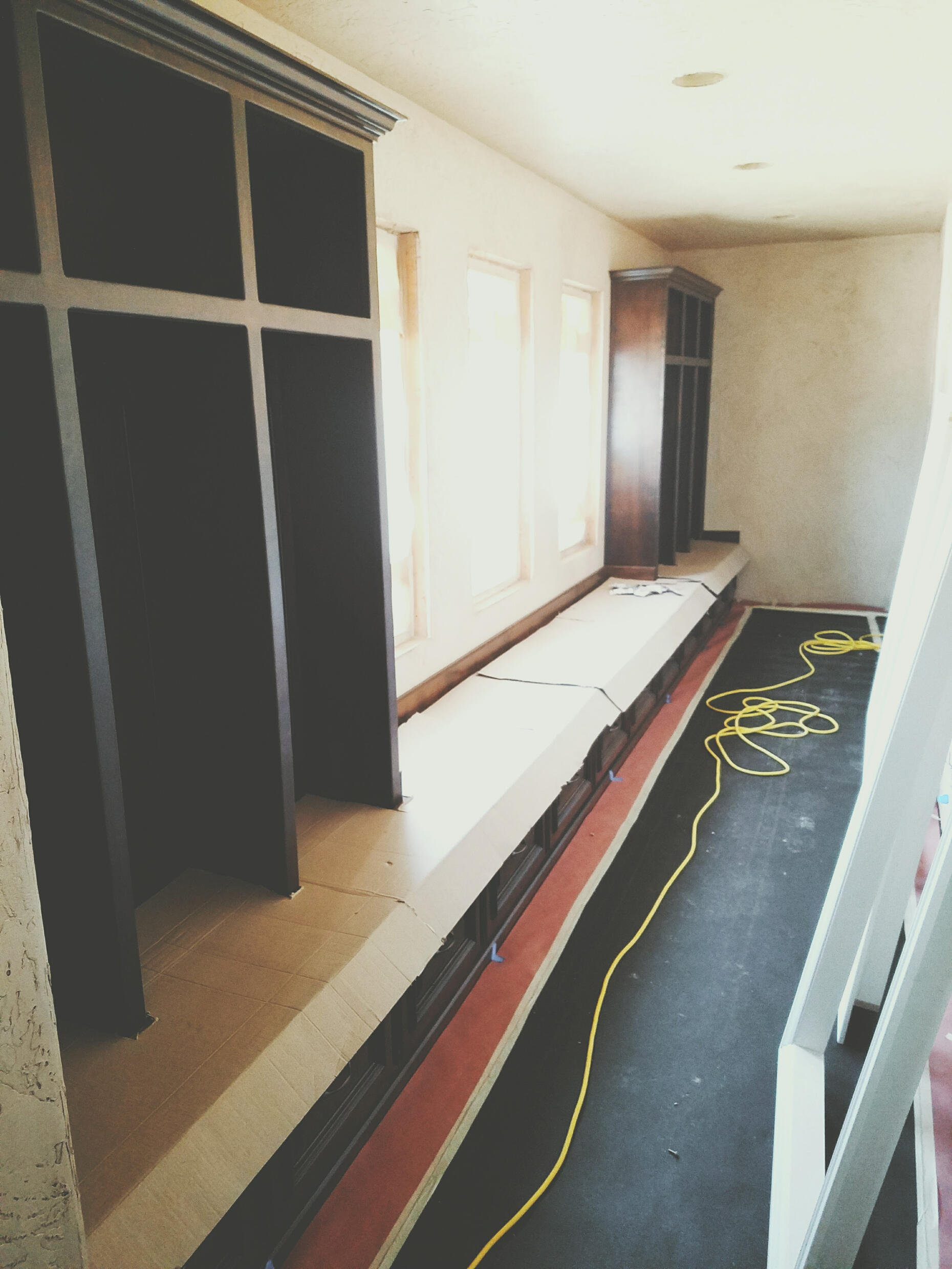 Custom mudroom built-in with bench seating, upper storage cubbies, and decorative trim work, designed by TrueForm Interiors for a high-end entryway in the Branson, Missouri area